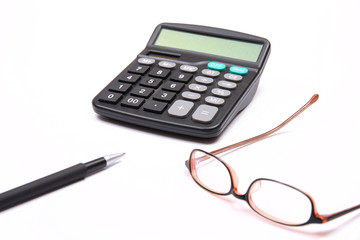 Calculator, glasses and pen on white background