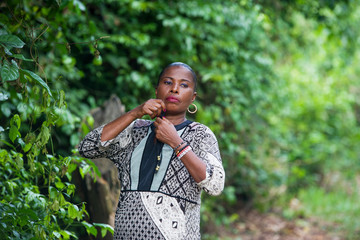 Beautiful and young woman in a casual shirt arranges her outfit