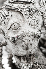 Closeup detail of metamorphic horror screaming face.  White Temple, Thailand
