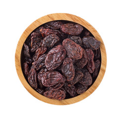 Raisins in wooden bowl isolated on white