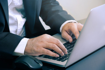 Businessman 's hands are typing on notebook keyboard    