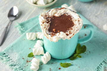 Cup of delicious cocoa with marshmallows on table
