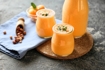 Composition with tasty melon smoothie on table