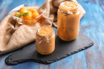 Jars of tasty melon smoothie on wooden table