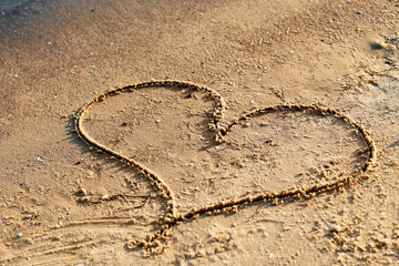 Heart drawn on beach sand