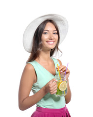 Young woman with mason jar of fresh lemonade on white background