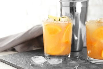 Glasses of tasty cold cocktail on slate plate