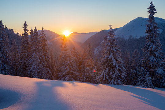 Magic sunset in the winter mountains after snowfall