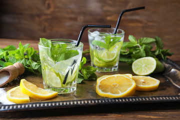 Glasses of fresh mojito on metal tray