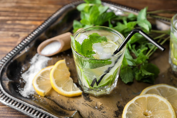 Glass of fresh mojito on metal tray