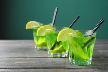 Glasses of fresh mojito on wooden table