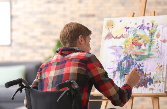 Young Artist In Wheelchair Painting Picture At Home