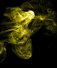 Fototapeta premium Yellow smoke on black background