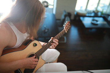 Fototapeta premium Young man with long hair with a guitar