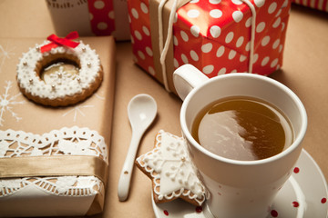 Close up of the cup of tea and Christmas presents