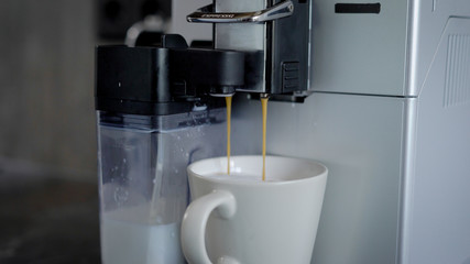Close up shot of a coffee machine making fresh hot black coffee.