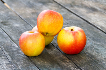 Fresh ripe apples on rustic wooden table