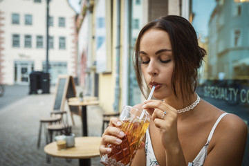 young brunette woman having ice tea