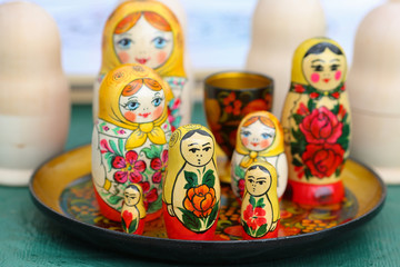 The russian doll Matryoshka with happy and angry faces, painted and not painted 