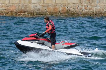 Obraz premium man is riding a hydrocycle