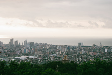 Fototapeta na wymiar Beatiful colorful Georgian cityscape of Batumi. Panoramic view. Grey clouds over calm Black Sea