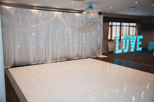 Wedding Dance floor and Big blue illuminated love letters on a wedding day