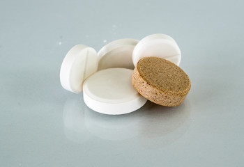 Large white round tablets lying on the glass