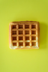 Belgian waffles on yellow background
