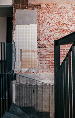 Industrial loft old grunge brick wall with concrete floor, black metal stairs handrail