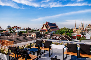 Evening at Wat Pho or Wat Phra Chetuphon view from hotel sky deck with table and chairs