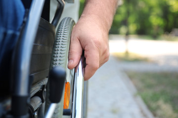 Senior man in wheelchair outdoors, closeup