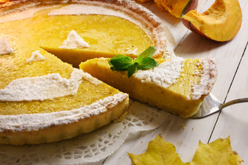 Pumpkin cake, cooked for the celebration of Halloween and decorated with mint twig. Food photography