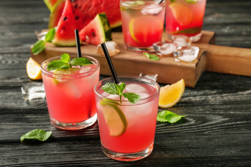 Glasses of fresh watermelon lemonade on wooden table