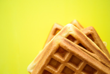 Belgian waffles on yellow background