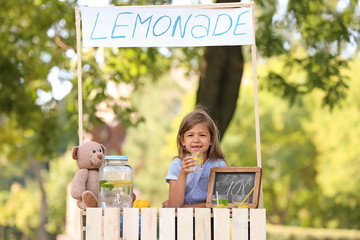 Little girl at lemonade stand in park