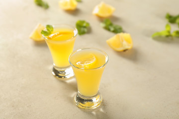 Glasses of fresh lemon cocktail on light table