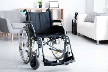 Empty modern wheelchair in light living room