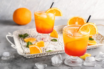 Fresh summer cocktail in glasses on grey table