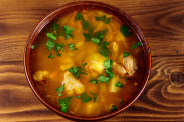 Kharcho soup with meat and rice on wooden table. Top view