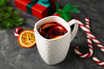 Cup of delicious mulled wine on grey table