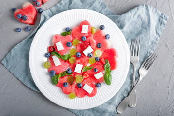 Plate with sweet watermelon salad on table