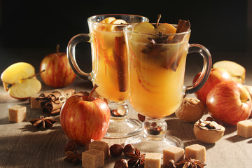 Two cups with hot cider in cold season with cinnamon and anise