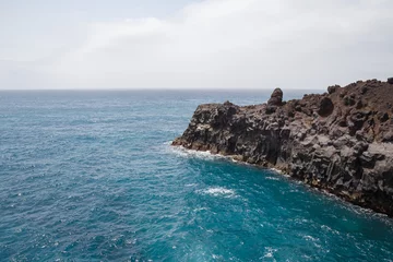 Fotobehang Rocky area formed by lava called Los Hervideros in Lanzarote, Canary Islands, Spain. © pablobenii