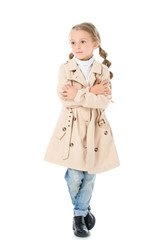 stylish child posing in autumn coat with crossed arms, isolated on white