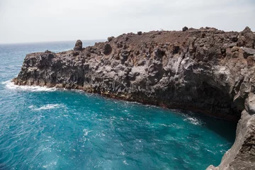 Gordijnen Rocky area formed by lava called Los Hervideros in Lanzarote, Canary Islands, Spain. © pablobenii