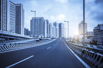 Fototapeta premium Road pavement and city building skyscrapers