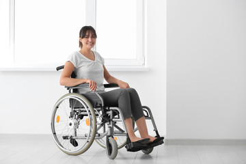 Young woman in wheelchair indoors