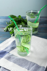 Glasses of cucumber infused water on wooden table