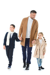 Fototapeta premium father holding hands with kids in autumn outfit, isolated on white