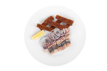 Snack, croutons from black, rye, bread, herring, fish lightly salted, onion, lemon slice, aperitif before alcohol on plate, white isolated background view from above. For the menu, restaurant, cafe